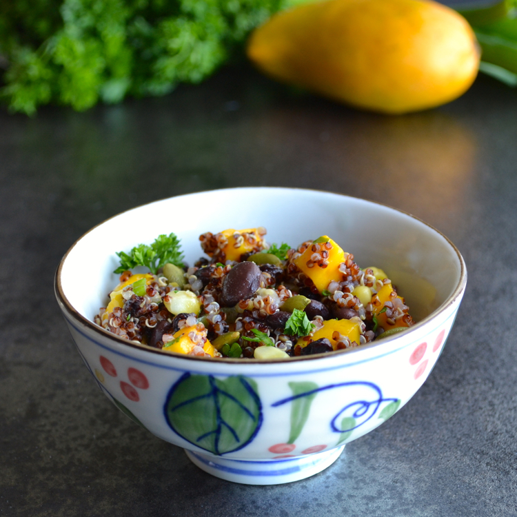 Red Quinoa and Mango Salad - this super healthy salad is full of black beans, mango, pepitas and currants with a citrusy dressing. | @tasteLUVnourish