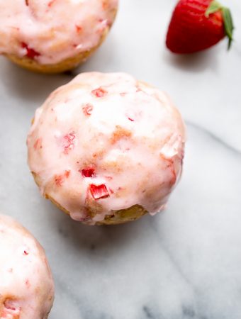 These Glazed Strawberry Muffins are irresistible! Made with fresh strawberries within and topped with a delicious strawberry glaze! Perfection! | From @tasteLUVnourish on www.tasteloveandnourish.com