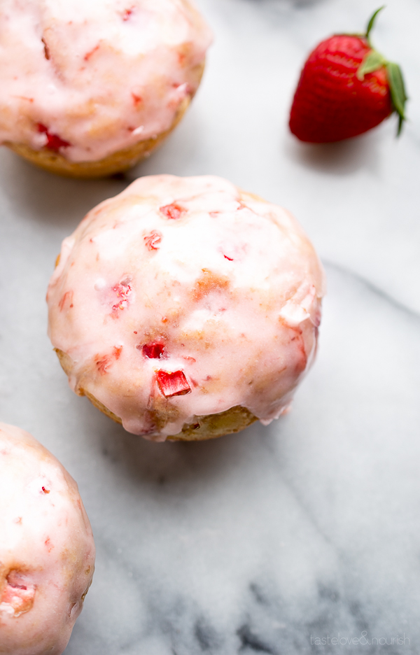 These Glazed Strawberry Muffins are irresistible! Made with fresh strawberries within and topped with a delicious strawberry glaze! Perfection! | From @tasteLUVnourish on www.tasteloveandnourish.com