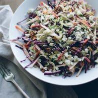 This crunchy Red Cabbage and Brussels Sprouts Slaw is my family's favorite salad! It's absolutely loaded with pecans, sunflower seeds, sweet apple slices and crumbles of blue cheese and topped with a Dijon Maple Vinaigrette. | @tasteLUVnourish