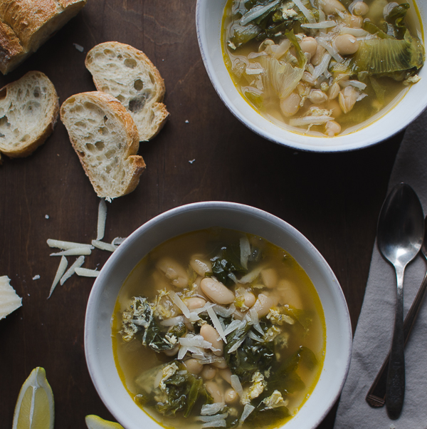 Escarole and Cannellini Bean Soup in Parmesan Broth - this recipe is amazing! Escarole and cannellini beans simmered in a light Parmesan broth then topped off with some lemon and more Parmesan. | @tasteLUVnourish