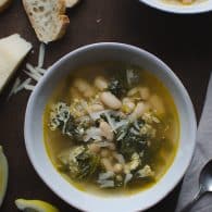 Escarole and Cannellini Bean Soup in Parmesan Broth - this recipe is amazing! Escarole and cannellini beans simmered in a light Parmesan broth then topped off with some lemon and more Parmesan. | @tasteLUVnourish