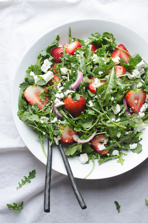 Baby Arugula and Strawberry Salad with Feta-this beautiful salad covers the spectrum of flavors and is a perfect pot luck favorite! From Caroline at Taste Love and Nourish