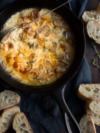 This decadent Baked Mushrooms and Fontina Dip recipe is a super easy crowd pleaser! Made with white wine and some fresh thyme, this cheesy dip has amazing flavor! | @tasteLUVnourish