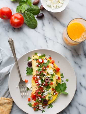 If you love bold Mediterranean flavors, the feta cheese, Kalamata olives, tomatoes and roasted red peppers in this simple and fluffy omelet are calling your name. | @tasteLUVnourish | Vegetarian | Gluten Free