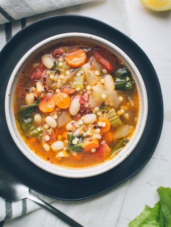 This simple, warming Escarole White Bean and Tomato Soup, full of complex flavors, is so nourishing and easily adapts to whatever you've got on hand. Make this your go-to winter soup. Naturally vegan with gluten-free options. From @tasteLUVnourish