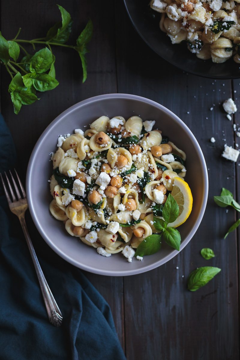 Orecchiette with Chickpeas Spinach and Feta is a simple and quick dinner that tastes incredible! In the time it takes to boil the pasta, you can prepare the rest of the ingredients and have dinner on the table in a flash. From @tasteLUVnourish #orecchiette #chickpeas #spinach #feta #easydinnerrecipes #pastarecipes