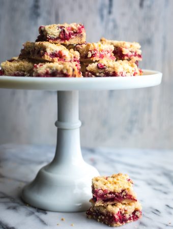 These Cranberry Bars are a simple, easy dessert that taste amazing! They've got a delicate, buttery, orange scented shortbread crust with a sweet, tangy cranberry filling. #tasteloveandnourish #cranberrybars #cookie #holiday #baking #recipe #easy #glutenfreeoptions