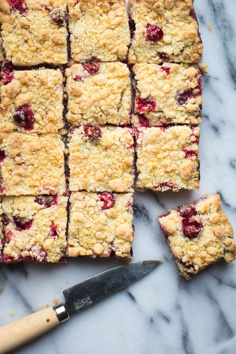 These Cranberry Bars are a simple, easy dessert that taste amazing! They've got a delicate, buttery, orange scented shortbread crust with a sweet, tangy cranberry filling. #tasteloveandnourish #cranberrybars #cookie #holiday #baking #recipe #easy #glutenfreeoptions