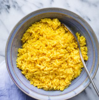 This easy Yellow Rice makes a tasty and fragrant side dish with antioxidant rich turmeric and so much flavor. It's deliciously vegan and gluten free! #yellowrice #rice #sidedish #recipe #easysidedish #turmeric #curcumin #tasteloveandnourish @tasteLUVnourish