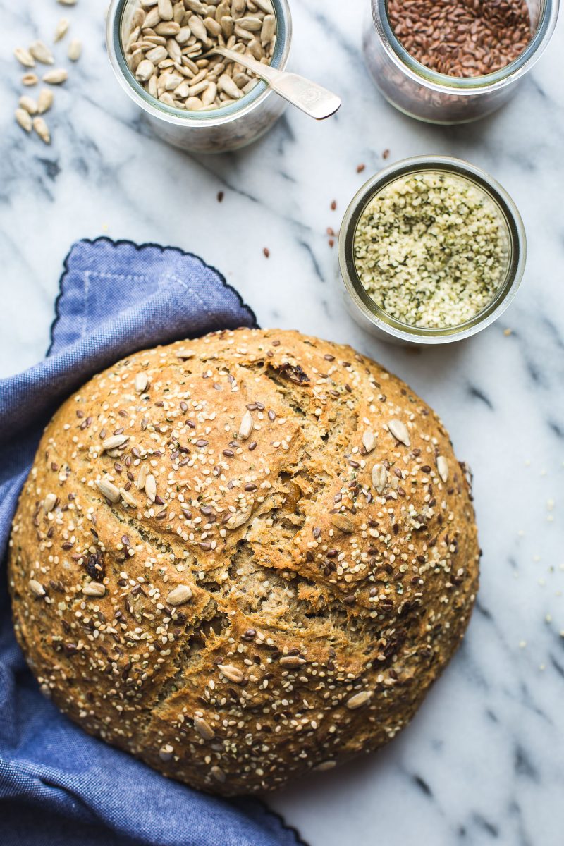 Seeded Soda Bread - This simple Seeded Soda Bread recipe yeilds a homey, delicious loaf speckled with nutty seeds and just a touch of golden raisins. So perfect with a bit of marmalade or just on its own. Plus, this bread has a bit of an unusual surprise… www.tasteloveandnourish.com #sodabread #seeded #wholewheat #irish #stpatricksday #flax #hemp #sunflower #sesame #easy #recipe #bread #vegan #tasteloveandnourish