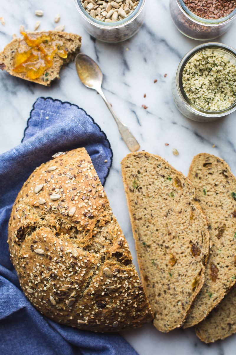 Seeded Soda Bread - This simple Seeded Soda Bread recipe yeilds a homey, delicious loaf speckled with nutty seeds and just a touch of golden raisins. So perfect with a bit of marmalade or just on its own. Plus, this bread has a bit of an unusual surprise… www.tasteloveandnourish.com #sodabread #seeded #wholewheat #irish #stpatricksday #flax #hemp #sunflower #sesame #easy #recipe #bread #vegan #tasteloveandnourish
