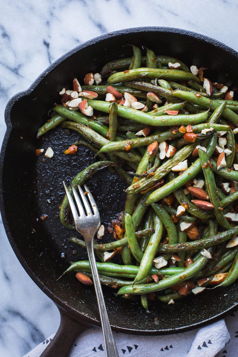 These spicy Seared Sriracha Green Beans with toasty, crunchy almonds and lots of garlic are the simplest and tastiest way to eat green beans! www.tasteloveandnourish.com #greenbeans #sriracha #almonds #takeout #vegan #glutenfree #sidedish #easy #healthy #recipe #dinner #tasteloveandnourish