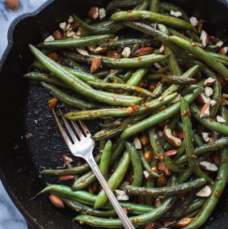These spicy Seared Sriracha Green Beans with toasty, crunchy almonds and lots of garlic are the simplest and tastiest way to eat green beans! www.tasteloveandnourish.com #greenbeans #sriracha #almonds #takeout #vegan #glutenfree #sidedish #easy #healthy #recipe #dinner #tasteloveandnourish