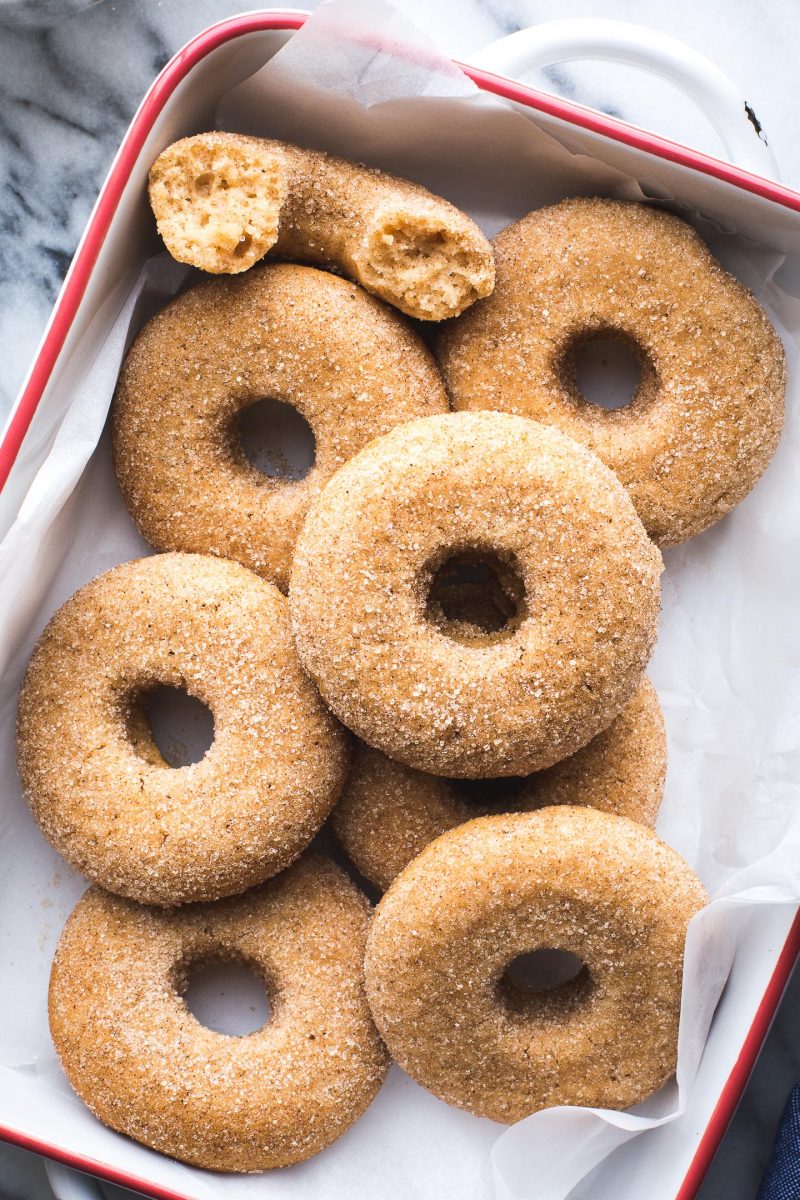 This Vegan Baked Apple Cider Donut recipe yields the tastiest donuts with lots of apple flavor and the perfect blend of spices. They'll definitely satisfy your biggest cider donut cravings! #vegan #baked #apple #cider #donut #doughnut #breakfast #snack #dessert #fall #recipe #tasteloveandnourish