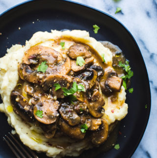Mushroom Miso Gravy over Garlic Mashed Potatoes - This flavorful Mushroom Miso Gravy recipe over the tastiest Garlic Mashed Potatoes makes the most cozy and simple meal.  #vegan #vegetarian #glutenfree #dinner #mushrooms #gravy #mashedpotatoes #comfortfood #hearty #healthy #recipe #tasteloveandnourish